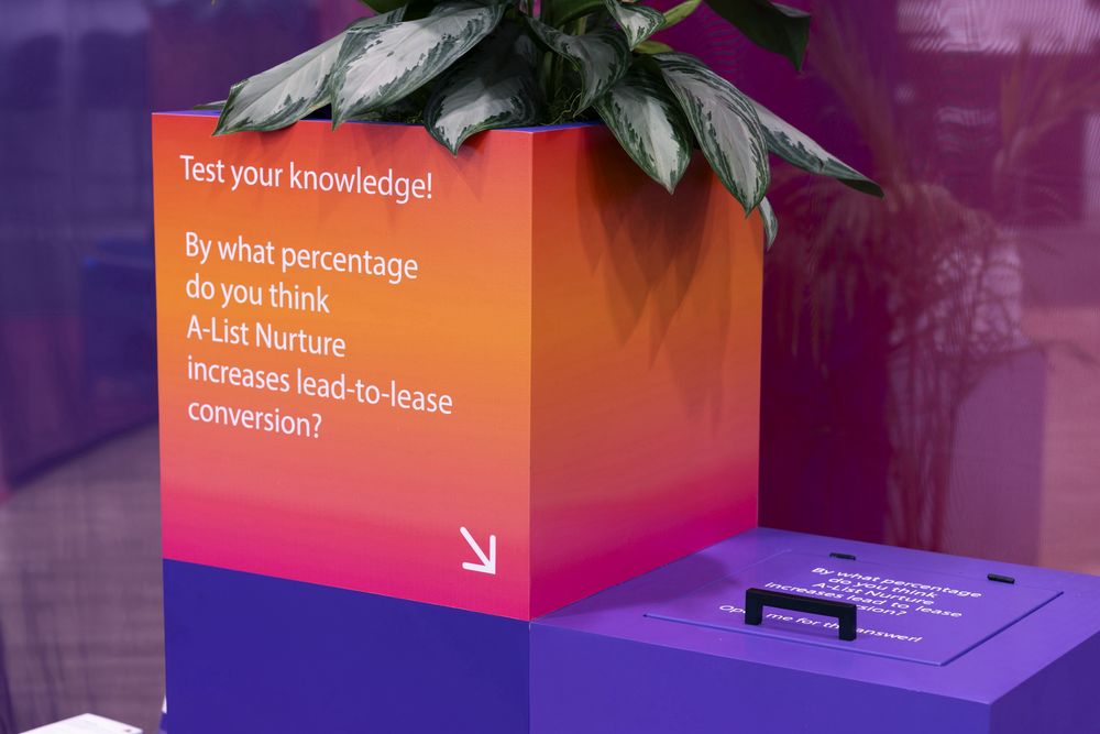 Interactive knowledge-test cube at the Apartment List booth, NAA Apartmentalize 2025