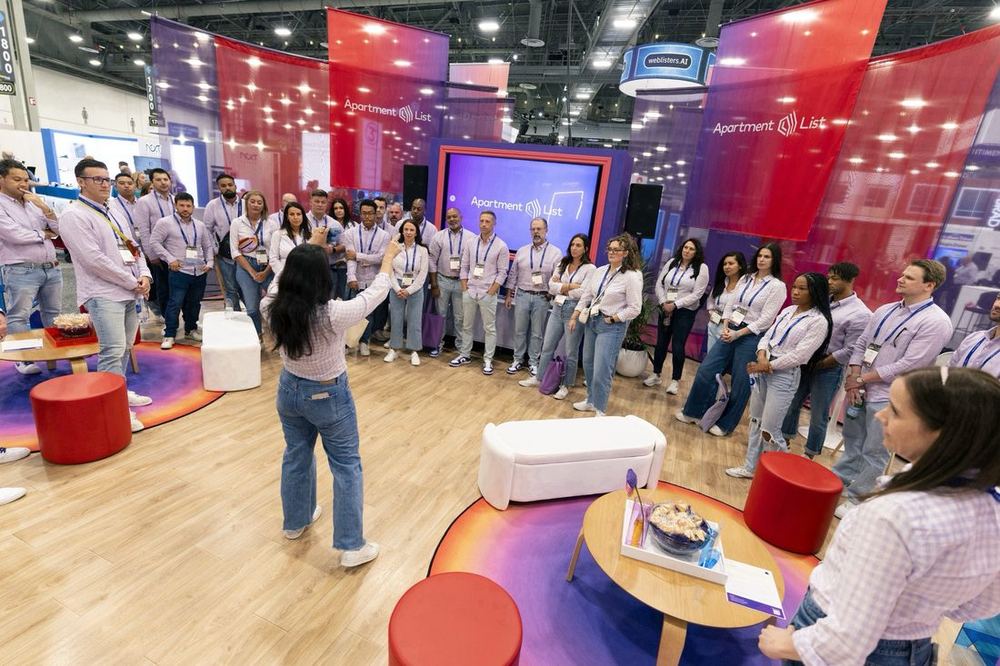 Apartment List team gathered for a briefing inside their NAA 2025 trade show booth