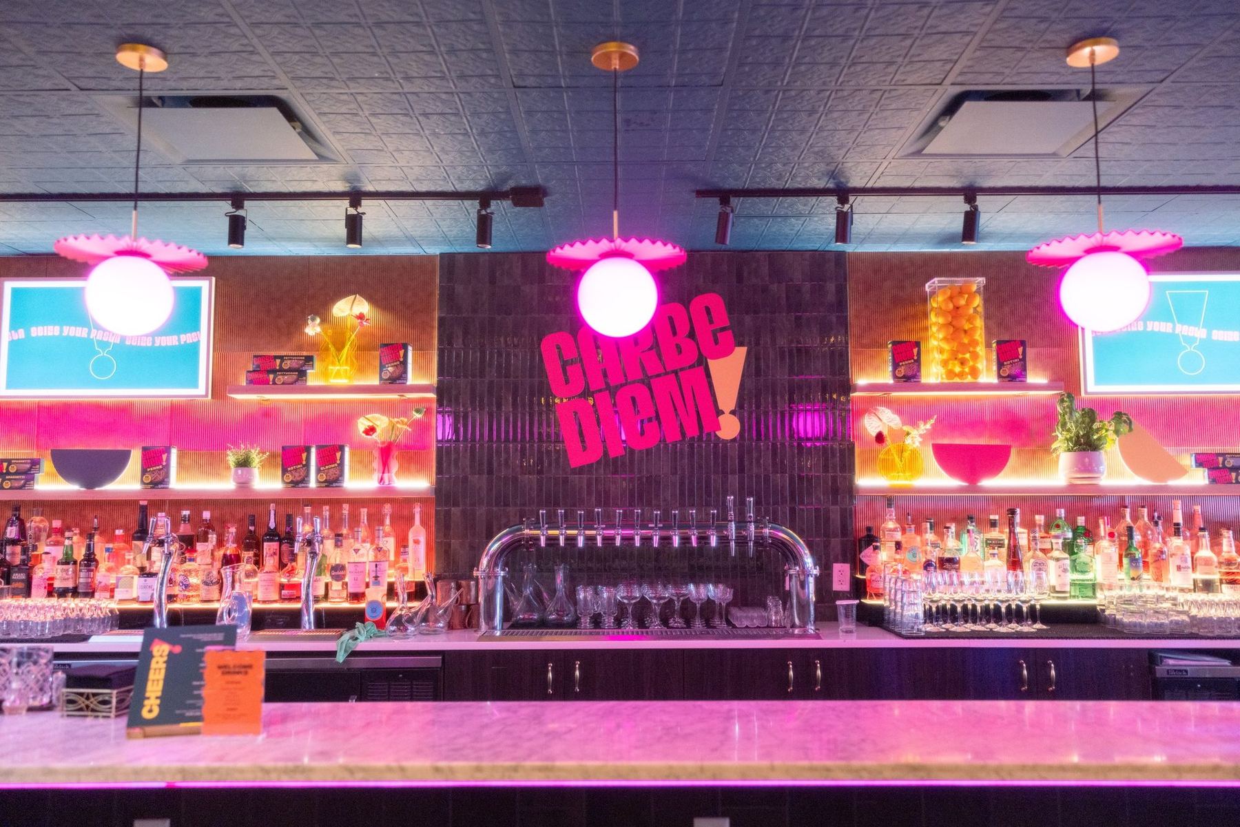 Carbe Diem pasta night restaurant takeover with pink neon, hanging florals, and a styled bar
