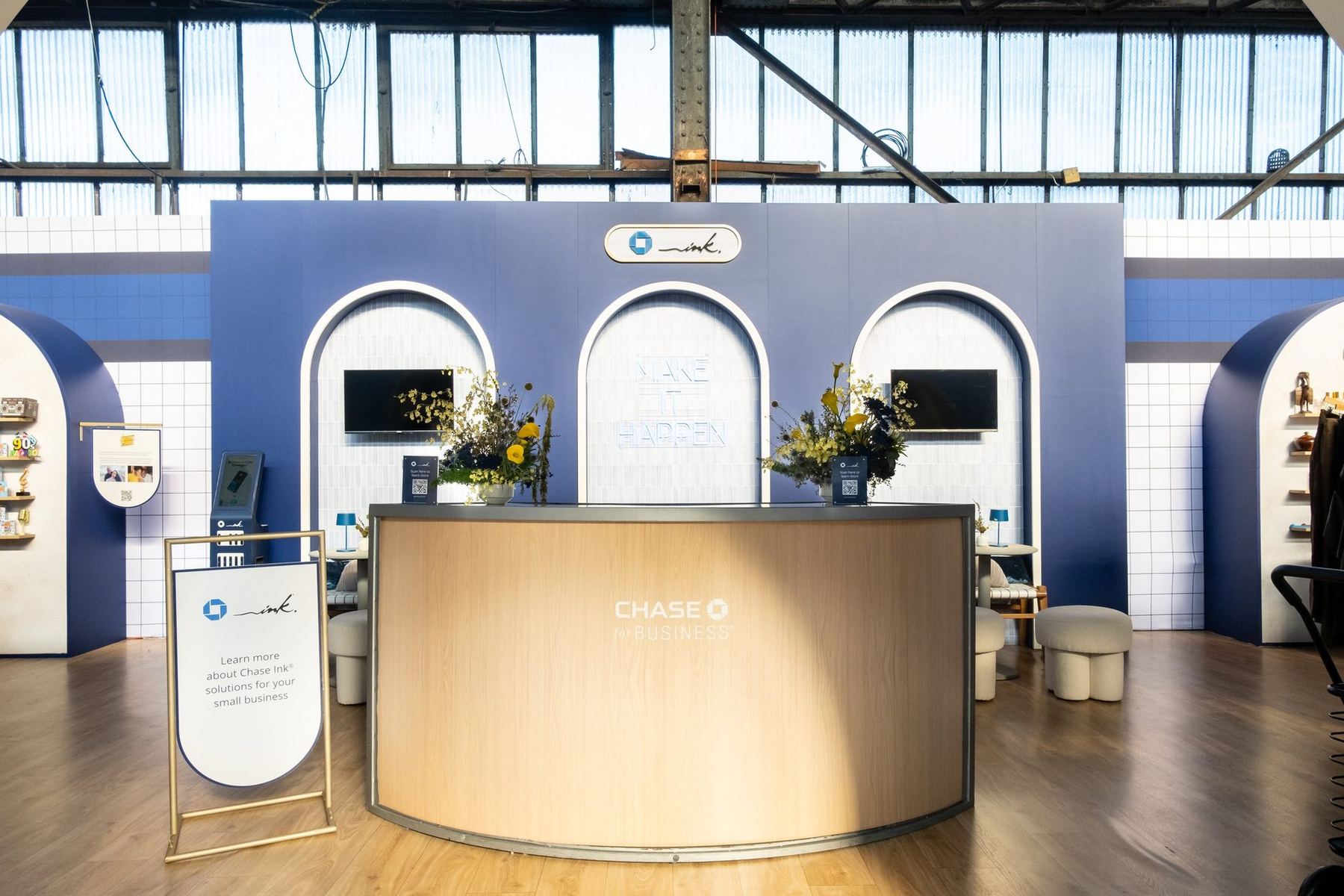 Chase Ink Marketplace at CultureCon with arched wood storefronts and a welcome desk