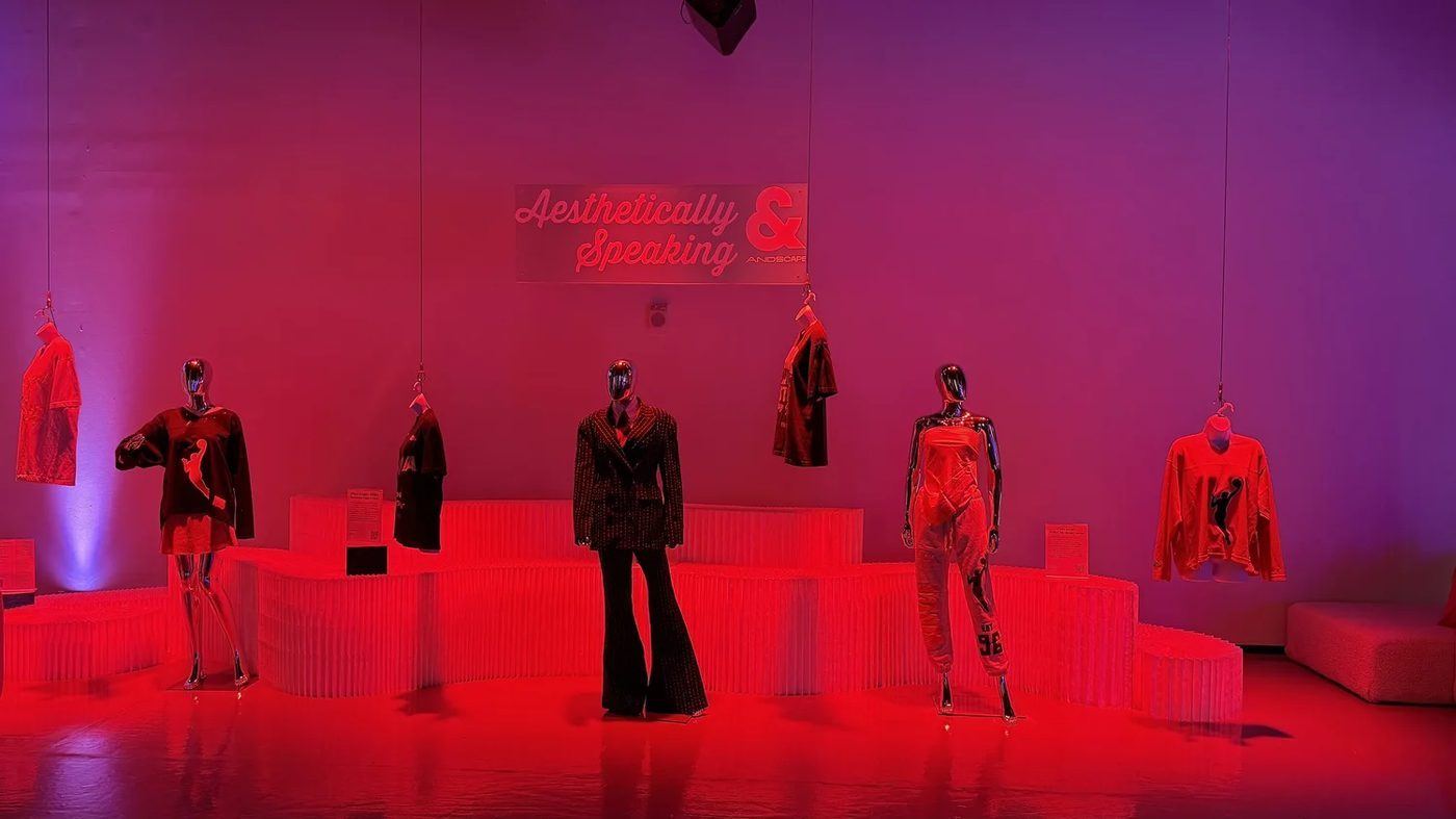 Red-lit fashion exhibit of WNBA player style on mannequins at House of ESPN during New York Fashion Week