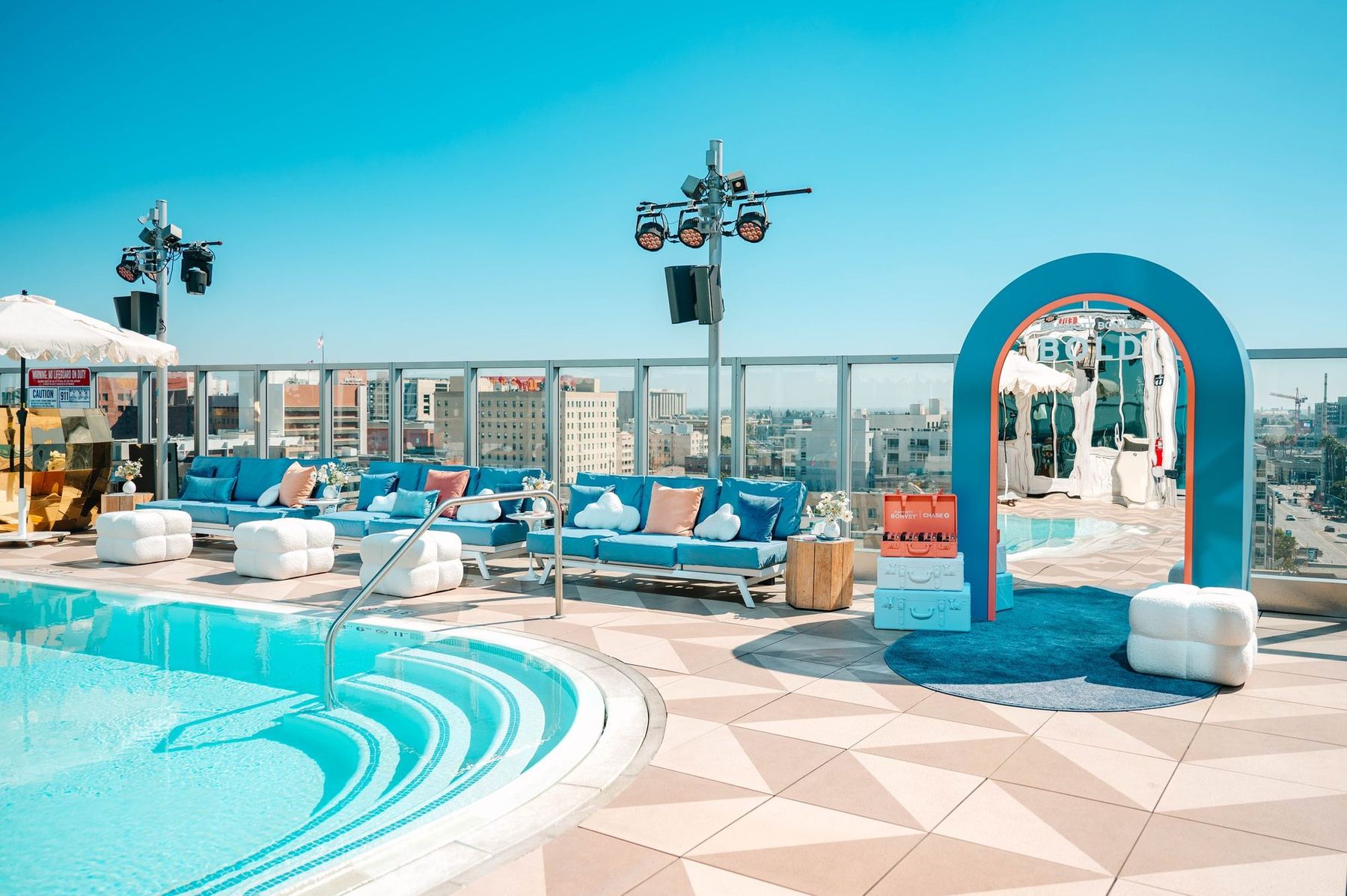 Rooftop pool takeover in downtown Los Angeles for the Marriott Bonvoy Bold card launch, with a blue arch and poolside lounges