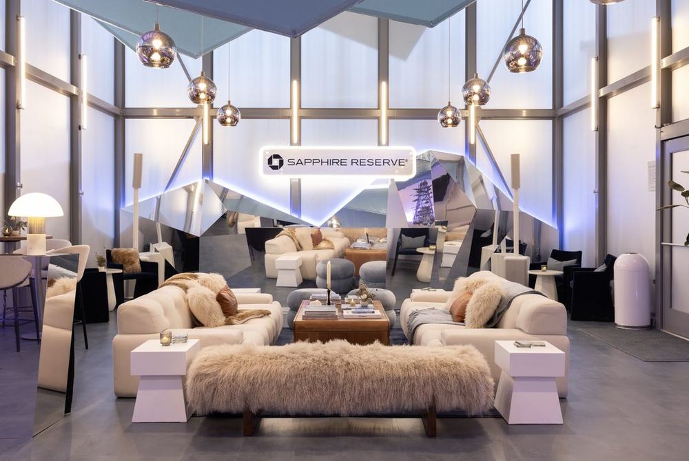 Chase Sapphire Reserve lounge at Sundance 2025 with white sofas, fur throws, and a faceted ceiling