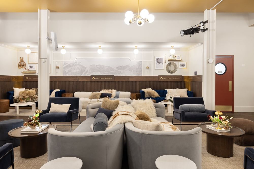 Chase Sapphire Reserve lounge at Le Depot in Park City with grey sofas and chandeliers